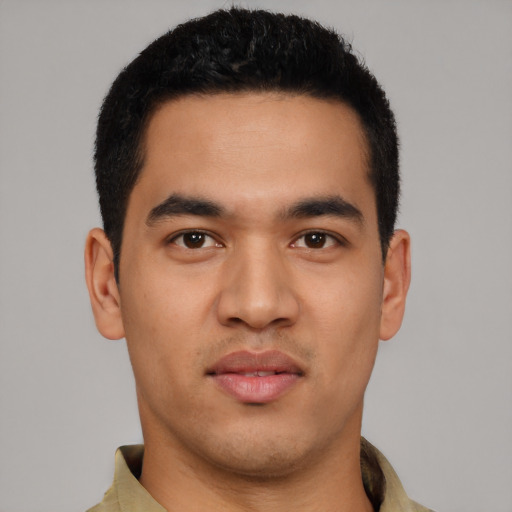 Joyful latino young-adult male with short  black hair and brown eyes