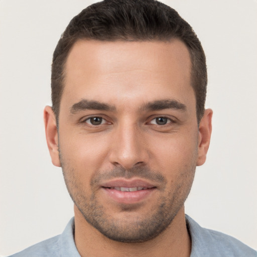 Joyful white young-adult male with short  brown hair and brown eyes