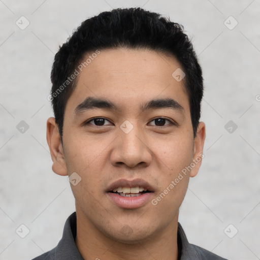 Joyful latino young-adult male with short  black hair and brown eyes