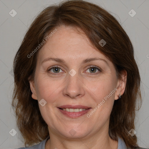 Joyful white adult female with medium  brown hair and grey eyes