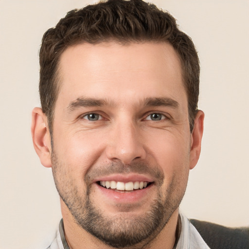 Joyful white young-adult male with short  brown hair and brown eyes