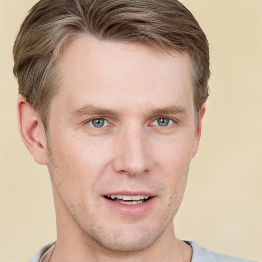 Joyful white adult male with short  brown hair and grey eyes