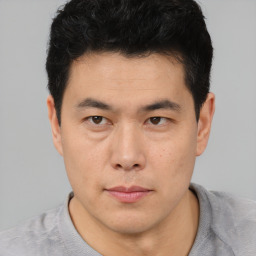 Neutral asian young-adult male with short  brown hair and brown eyes