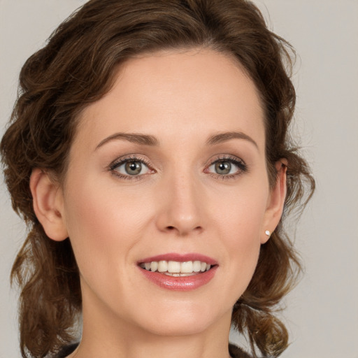 Joyful white young-adult female with medium  brown hair and green eyes