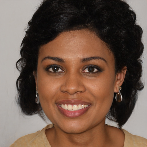 Joyful black young-adult female with medium  brown hair and brown eyes