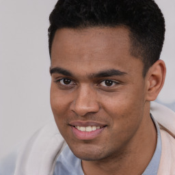 Joyful white young-adult male with short  black hair and brown eyes