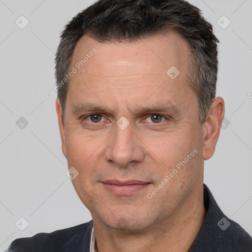 Joyful white adult male with short  brown hair and brown eyes