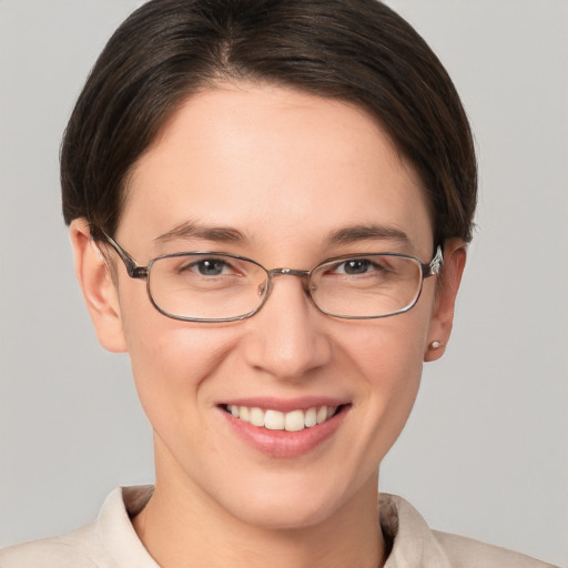 Joyful white young-adult female with short  brown hair and grey eyes