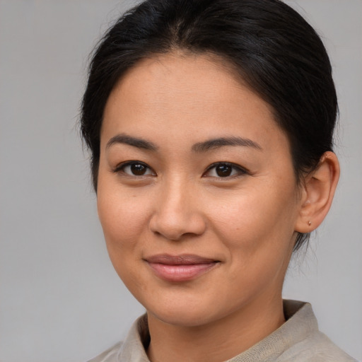 Joyful asian young-adult female with medium  brown hair and brown eyes