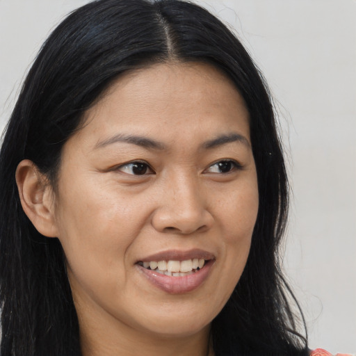 Joyful asian young-adult female with long  brown hair and brown eyes