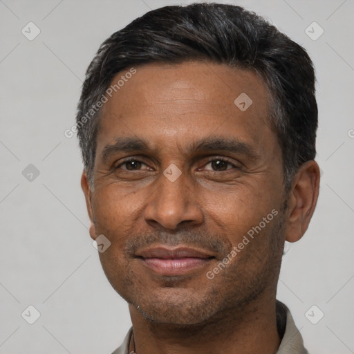 Joyful white adult male with short  black hair and brown eyes