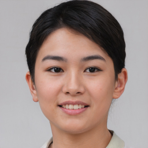 Joyful asian young-adult female with short  black hair and brown eyes