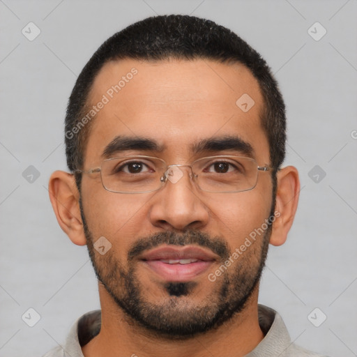 Joyful latino young-adult male with short  black hair and brown eyes