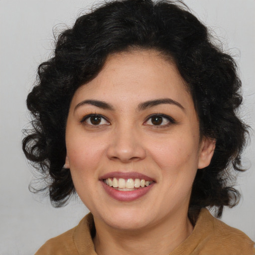 Joyful latino young-adult female with medium  brown hair and brown eyes