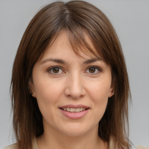 Joyful white young-adult female with medium  brown hair and brown eyes