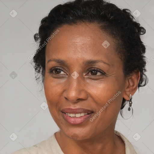 Joyful black adult female with medium  brown hair and brown eyes