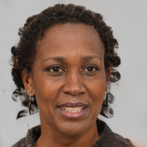 Joyful black adult female with medium  brown hair and brown eyes
