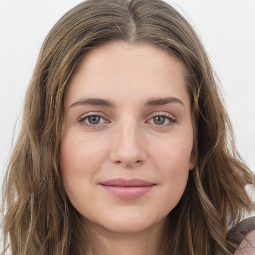 Joyful white young-adult female with long  brown hair and green eyes