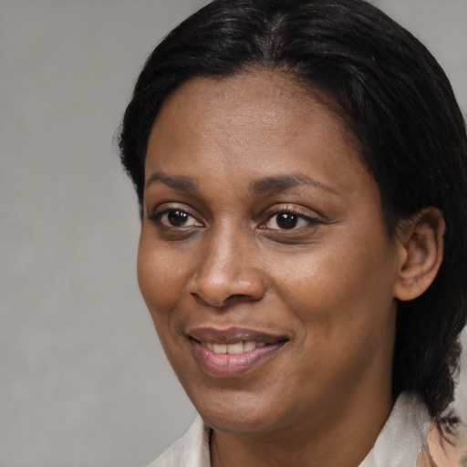 Joyful black adult female with medium  black hair and brown eyes