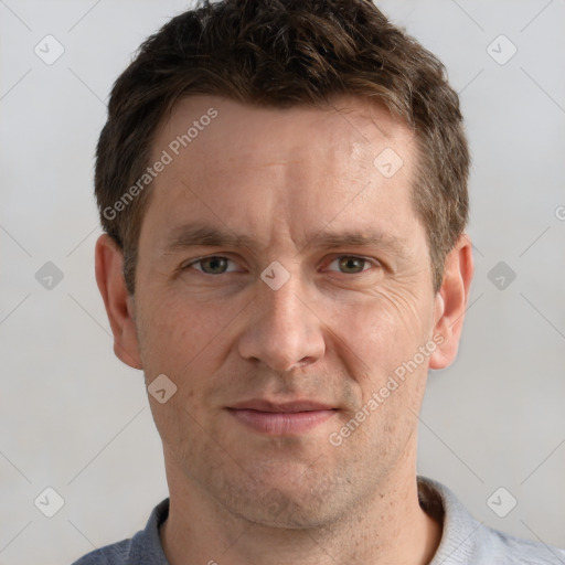 Joyful white adult male with short  brown hair and grey eyes