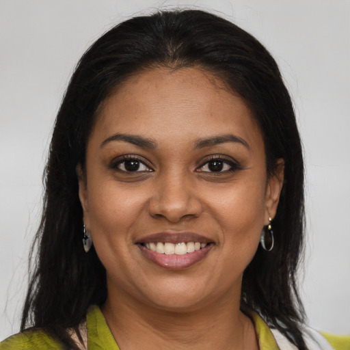 Joyful black young-adult female with medium  brown hair and brown eyes