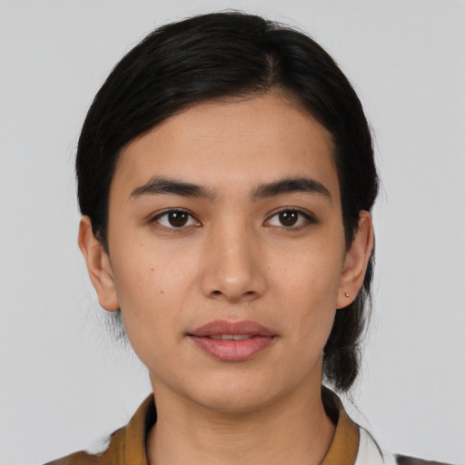 Joyful white young-adult female with medium  black hair and brown eyes