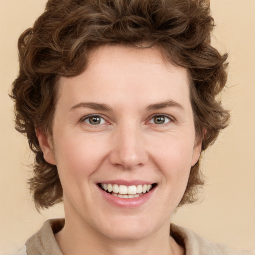 Joyful white young-adult female with medium  brown hair and green eyes