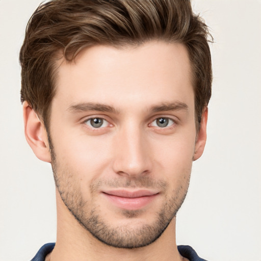 Joyful white young-adult male with short  brown hair and grey eyes