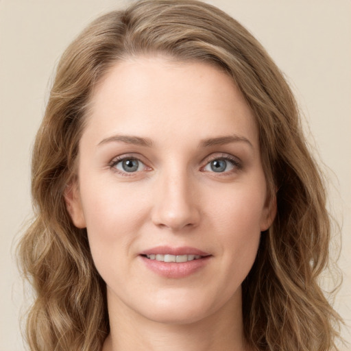 Joyful white young-adult female with long  brown hair and green eyes