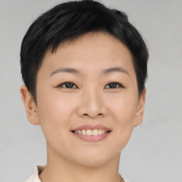 Joyful asian young-adult female with short  brown hair and brown eyes