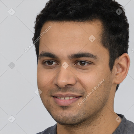 Joyful latino young-adult male with short  black hair and brown eyes