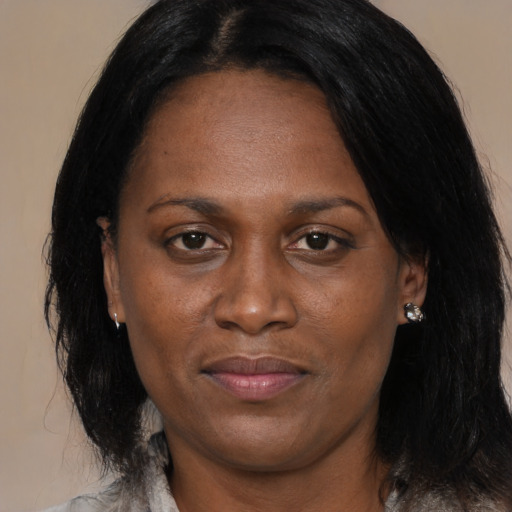 Joyful black adult female with medium  brown hair and brown eyes