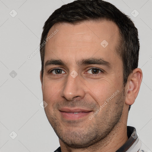 Joyful white adult male with short  brown hair and brown eyes