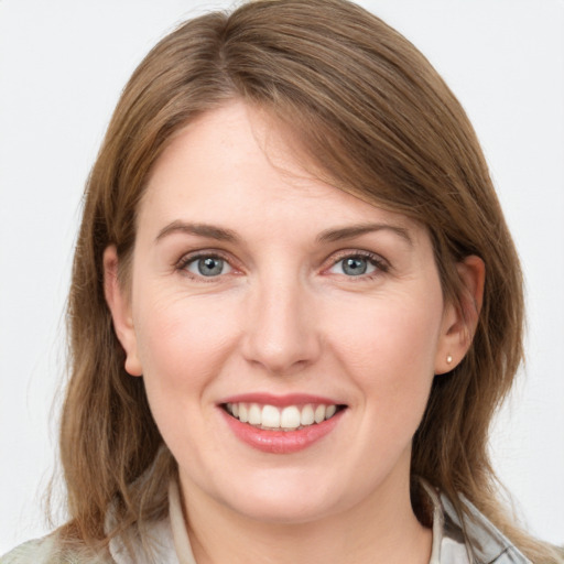 Joyful white young-adult female with medium  brown hair and green eyes