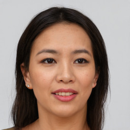 Joyful asian young-adult female with long  brown hair and brown eyes