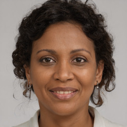 Joyful black adult female with medium  brown hair and brown eyes