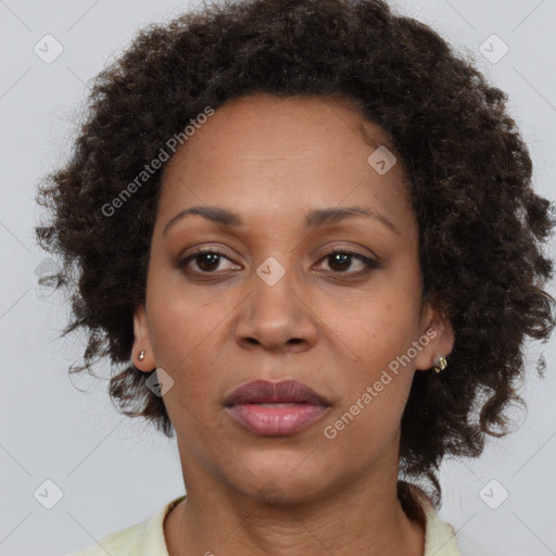 Joyful black adult female with short  brown hair and brown eyes