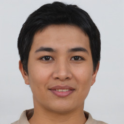 Joyful asian young-adult male with short  brown hair and brown eyes