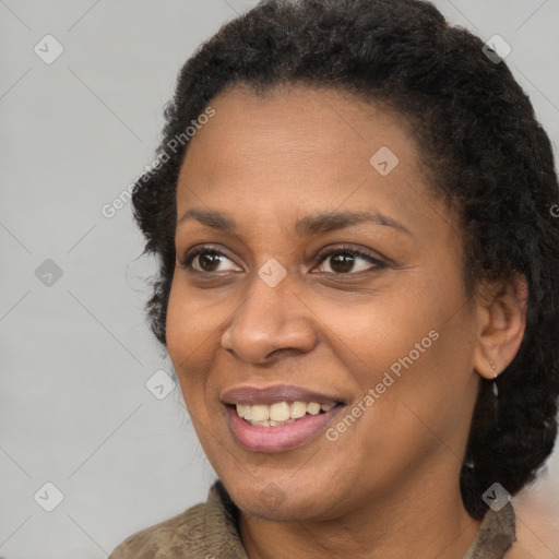 Joyful black young-adult female with medium  brown hair and brown eyes