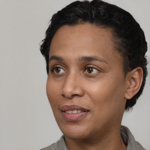 Joyful black adult female with short  black hair and brown eyes