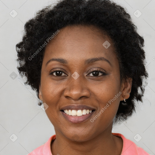 Joyful black adult female with short  brown hair and brown eyes