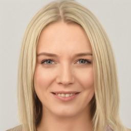 Joyful white young-adult female with long  brown hair and blue eyes