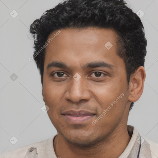 Joyful black young-adult male with short  black hair and brown eyes