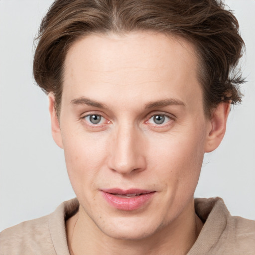 Joyful white young-adult female with short  brown hair and grey eyes