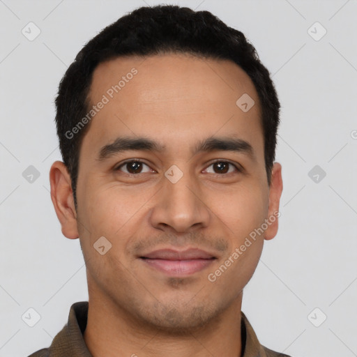 Joyful latino young-adult male with short  brown hair and brown eyes