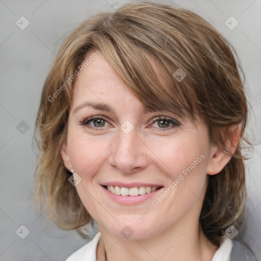 Joyful white adult female with medium  brown hair and grey eyes