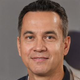Joyful white adult male with short  brown hair and brown eyes