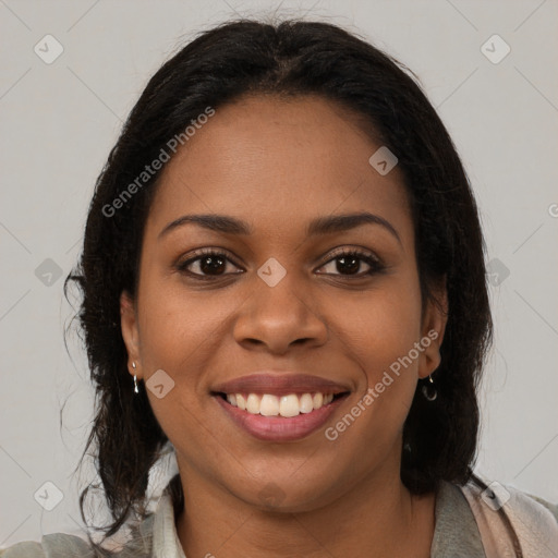 Joyful black young-adult female with long  brown hair and brown eyes