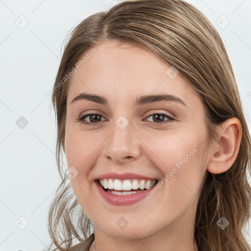 Joyful white young-adult female with long  brown hair and green eyes