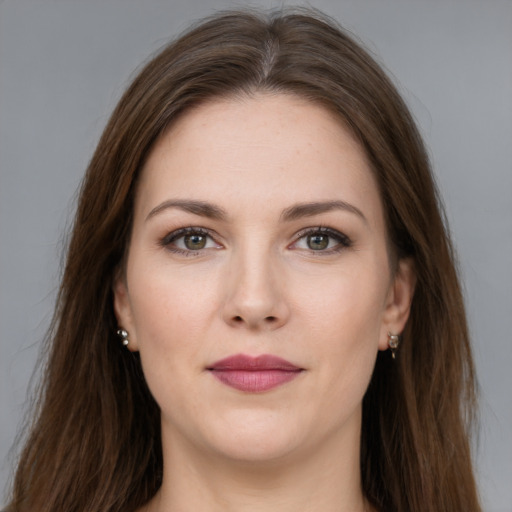 Joyful white young-adult female with long  brown hair and grey eyes